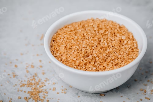 Preview: Brown sugar in white bowl on gray stone background
