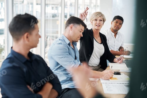 Preview: Shot of a mature businesswoman raising her hand to ask questions during a meeting