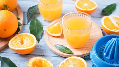 Preview: Fruit squeezer and ripe fresh oranges on blue wooden table top