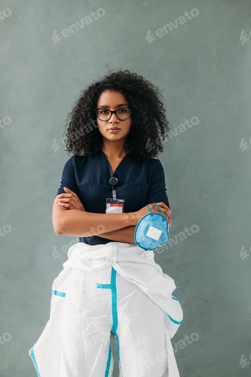 Preview: Female Healthcare Professional with Mask and Gown