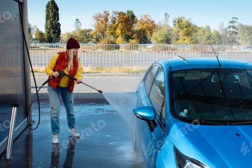 Preview: portrait young, smiling, happy, attractive woman washing automobile at manual car washing self