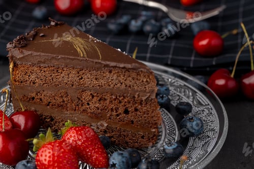 Preview: Piece of chocolate cake served with fresh berries