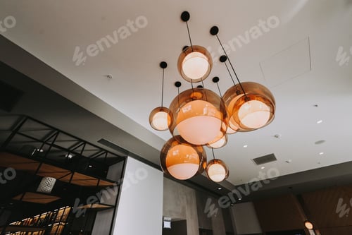 Preview: Low angle shot of unique and modern chandelier in a minimalistic bedroom