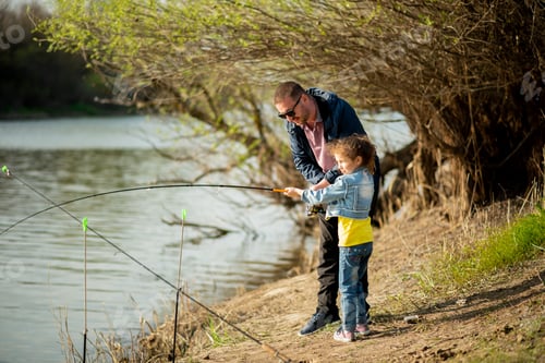 Preview: A dad and his daughter are fishing in the river.
