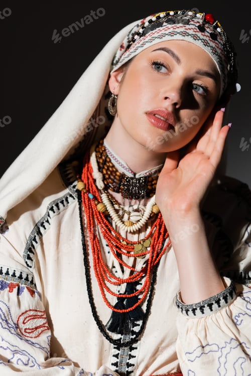 Preview: portrait of ukrainian woman in traditional shirt with red ornament and headwear looking away