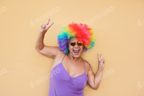 Preview: Happy Senior Woman Having Fun With Colorful Wig