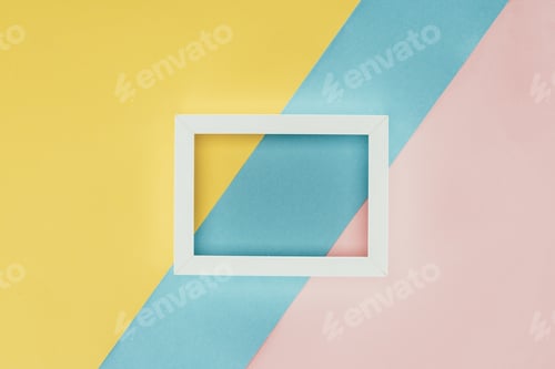 Preview: top view of white empty wooden frame on colorful background