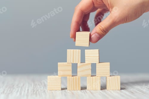 Preview: Hand arranging wood cube stacking as step stair. Business concept growth success process