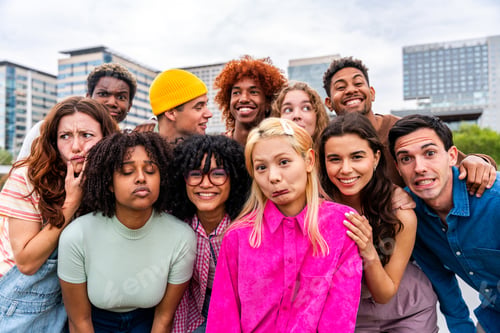 Preview: Happy playful multiethnic group of young friends bonding outdoors