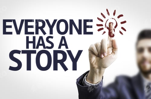 Preview: Business Man Pointing To Transparent Board With Text: Everyone Has A Story