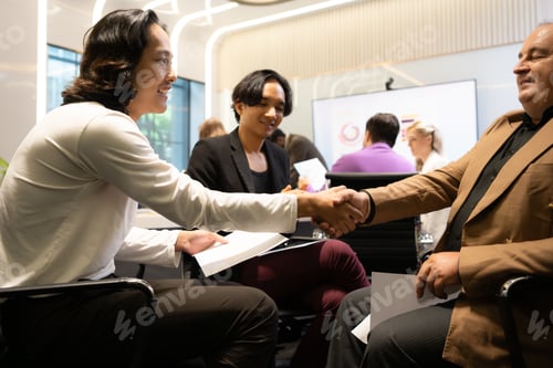 Preview: Group of diverse business people attending a meeting in a modern office.