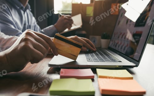 Preview: Group of friends are together looking at products on a laptop computer and using credit cards