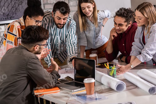 Preview: Group of modern business people in casual wear discussing architectural designs.