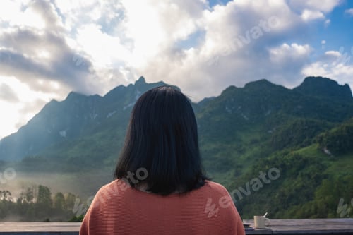 Preview: asian woman sitting and drink coffee relax with mountain view