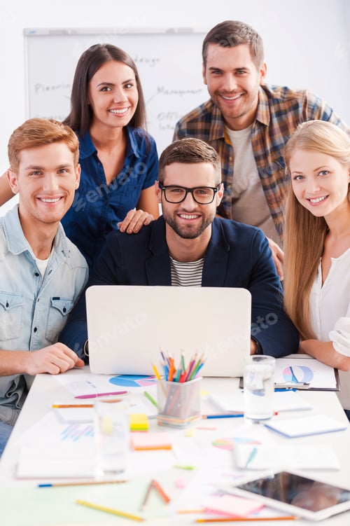 Preview: Successful team. Group of creative business people in smart casual wear working together and smiling