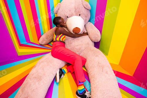 Preview: Beautiful young woman having fun inside a rainbow box room