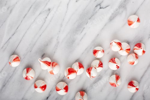 Preview: Peppermint meringues on a marble table, Christmas background