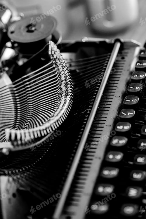 Preview: Grayscale closeup shot of an old vintage typewriter with blurred background