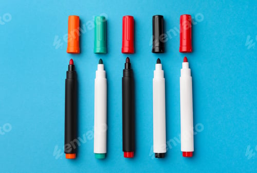 Preview: Bright color markers on light blue background, flat lay