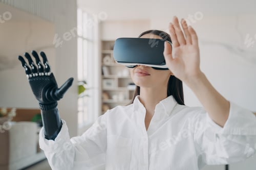 Preview: Happy handicapped girl in vr glasses at home. Woman with artificial hand is excited with 3d vision.