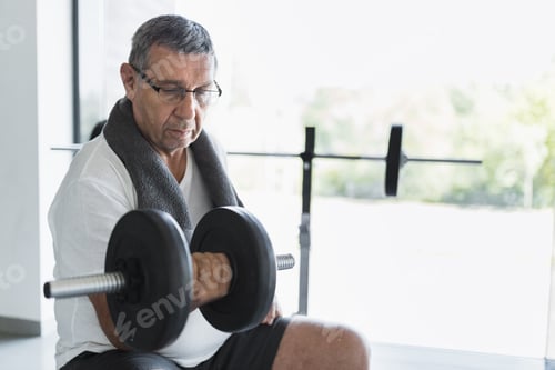 Preview: Active senior exercising in a gym