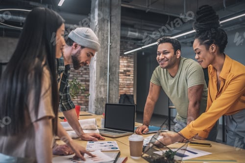 Preview: Four interracial smiling people in office