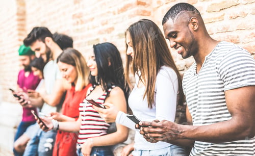 Preview: Multiracial friends group using smartphone at university college break