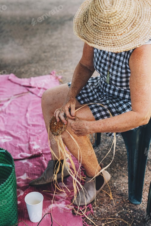 Preview: Old female weaving basket on the craft workshop. Hands holding the craftwork, close up shot