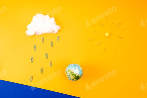 Preview: top view of environment composition with earth globe and cloud with sun made of paper clips on