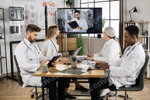 Preview: Diverse doctors having video call with colleague at clinic