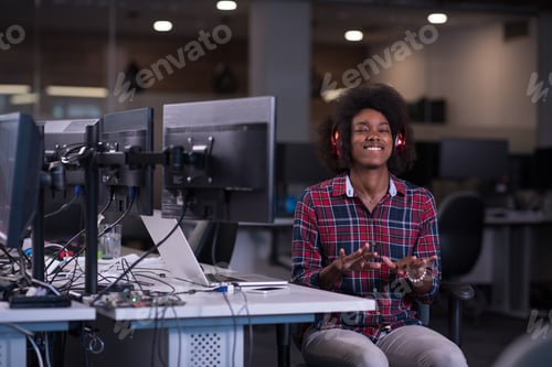 Preview: woman at her workplace in startup business office listening musi