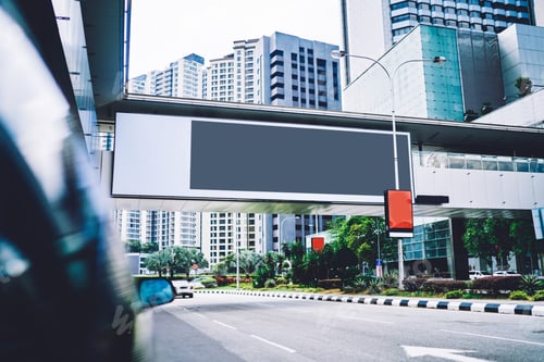 Preview: Empty gray banner over roadway in megapolis