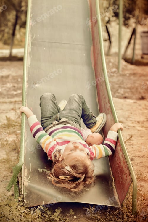 Preview: Little girl playing as she is sleeping on the slide