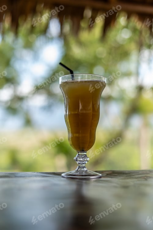 Preview: Sugarcane juice in glass on nature background