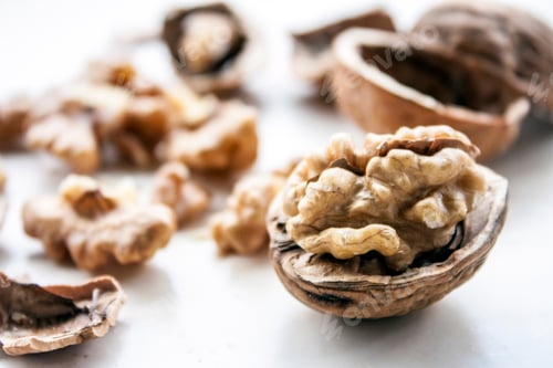 Preview: Half walnut, walnut kernels and broken shells, white background