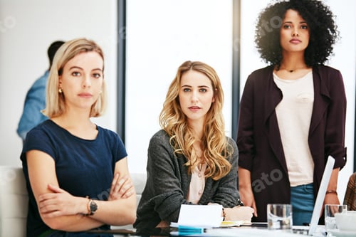 Preview: Serious about our work ethic. Portrait of a group of young businesswomen having a meeting at work.
