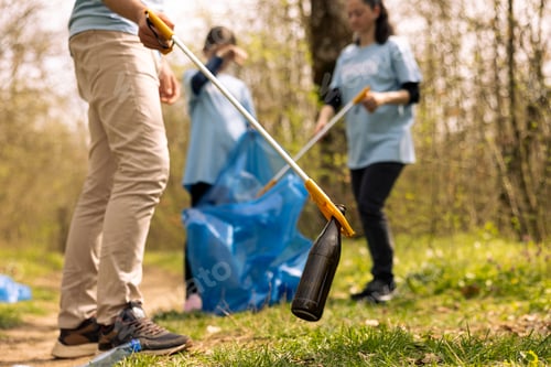 Preview: Team of volunteers collecting garbage and plastic waste to recycle