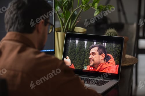 Preview: Man have a video call via laptop at home