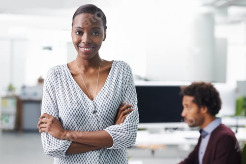 Preview: Portrait of a young business woman standing with her arms crossed