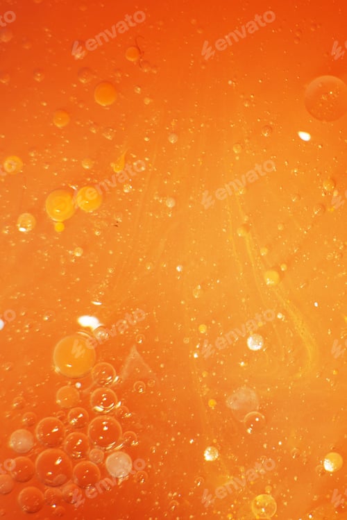 Preview: Gold Oil bubbles close up. circles of orange water macro. abstract shiny yellow background