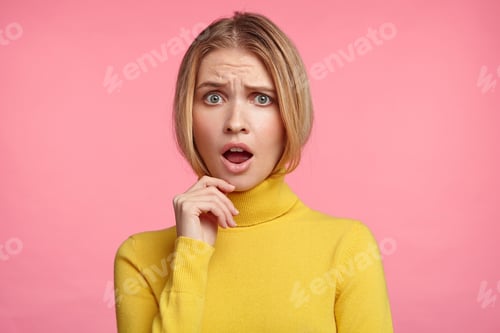 Preview: Horizontal portrait of beautiful stupefied woman keeps mouth opened, has upset expression, dressed c
