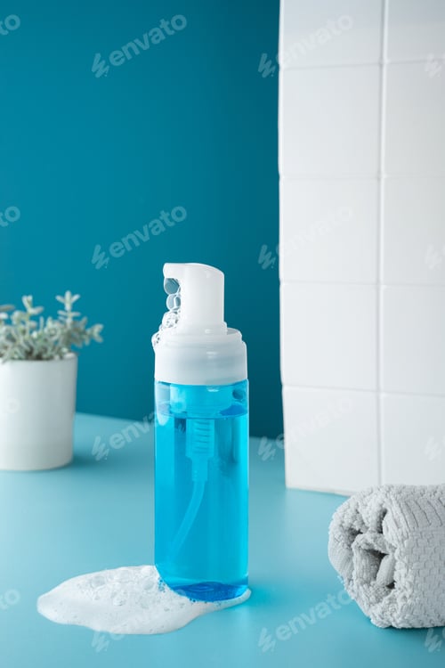 Preview: Beauty product mockup. Wellness packaging. Blue bottle, Cleaning cosmetic. Plastic pump bottle for a