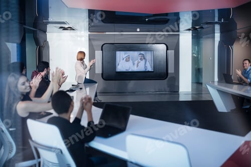 Preview: Business people applauding international customers in video conference