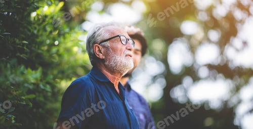 Preview: Senior Man with Beard Standing with Adult