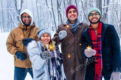 Preview: Image of a happy young friends with sparklers at Christmas party
