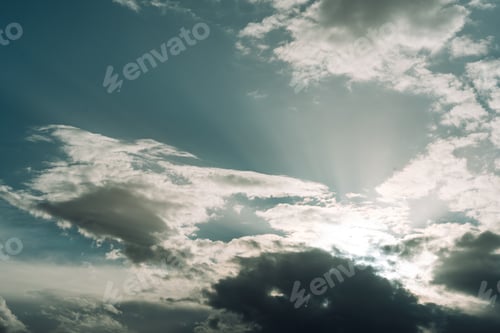 Preview: Blue sky with white clouds through which the sun shines through