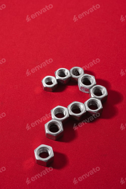 Preview: Question mark, made with steel nuts on red cloth background, leaving space for advertising text