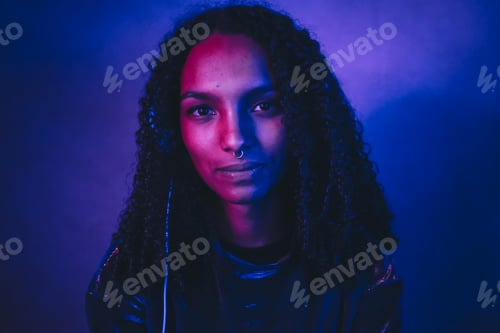 Preview: Artistic portrait with color lights of a young woman