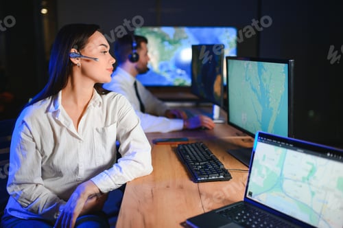 Preview: Portrait of cheerful woman and man working via headset microphone while sitting on navigation