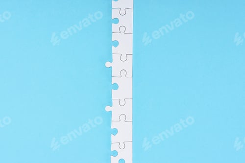 Preview: top view of white puzzle pieces arranged on blue backdrop